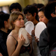 Students waiting in line for food holding plates